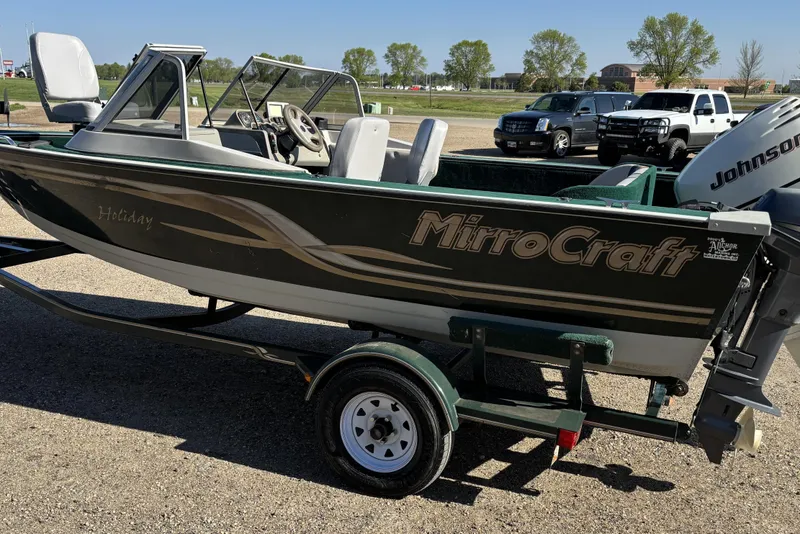 Slide: The Image of 2003 MirroCraft 1737 Holiday boat with Johnson outboard motor on trailer. - 1