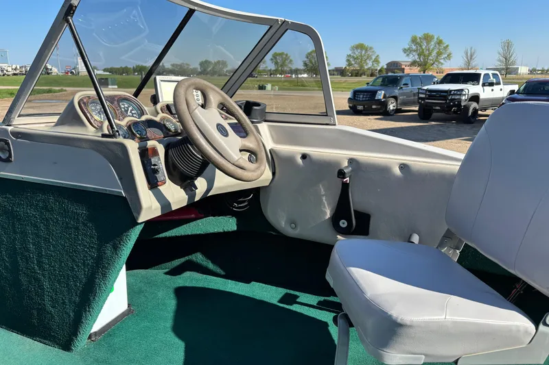 Slide: The Image of 2003 MirroCraft 1737 Holiday boat interior with steering wheel and dashboard controls. - 11