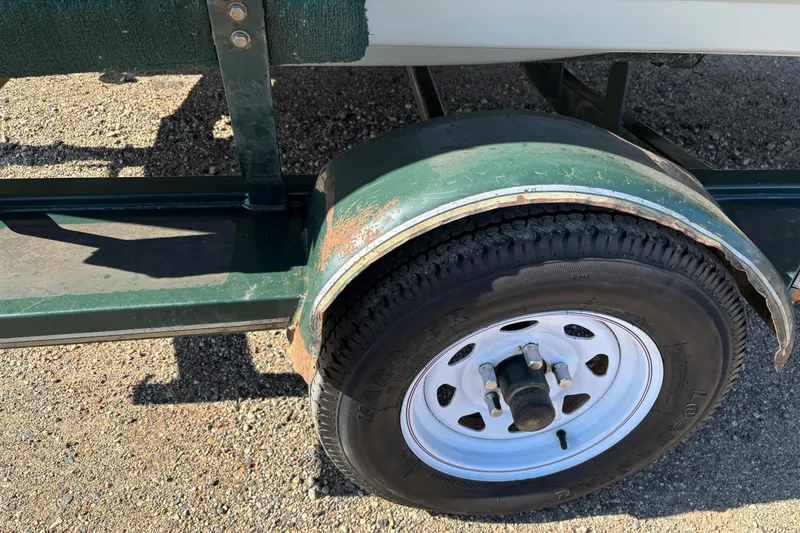 Slide: The Image of Trailer wheel of a 2003 MirroCraft 1737 Holiday boat, showing rust and wear. - 15