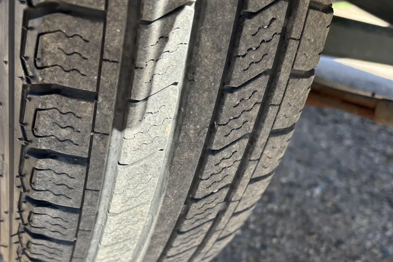 Slide: The Image of Close-up of a tire tread on a 2003 MirroCraft 1737 Holiday trailer. - 16