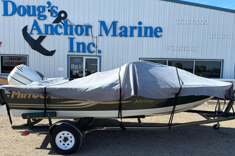 Slide: The Image of 2003 MirroCraft 1737 Holiday boat covered, parked outside Doug's Anchor Marine Inc. - 17