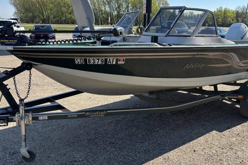 Slide: The Image of 2003 MirroCraft 1737 Holiday boat on trailer, parked outdoors. - 2