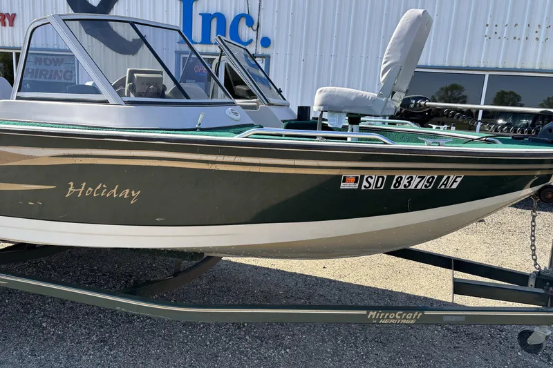 Slide: The Image of 2003 MirroCraft 1737 Holiday boat on trailer, parked outside a building. - 4