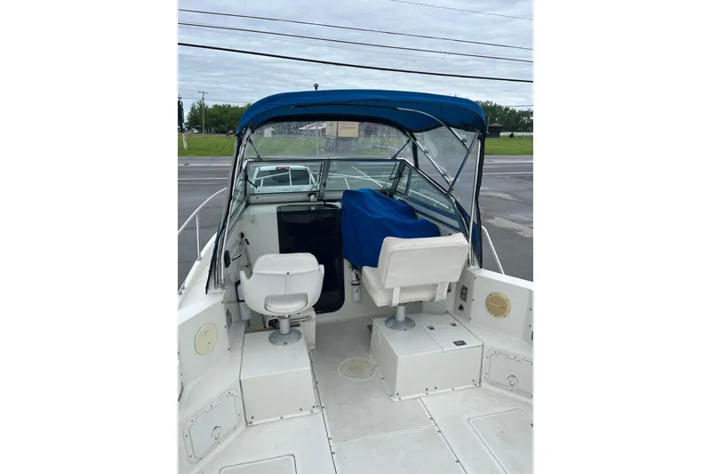 Slide: The Image of 1995 Celebrity 2500 Fish Hawk boat interior with blue canopy and seating. - 12