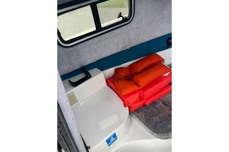 Slide: The Image of Interior of 1995 Celebrity 2500 Fish Hawk boat with life jackets and window view. - 17