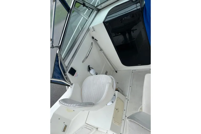Slide: The Image of Interior view of a 1995 Celebrity 2500 Fish Hawk boat, featuring seating and controls. - 9