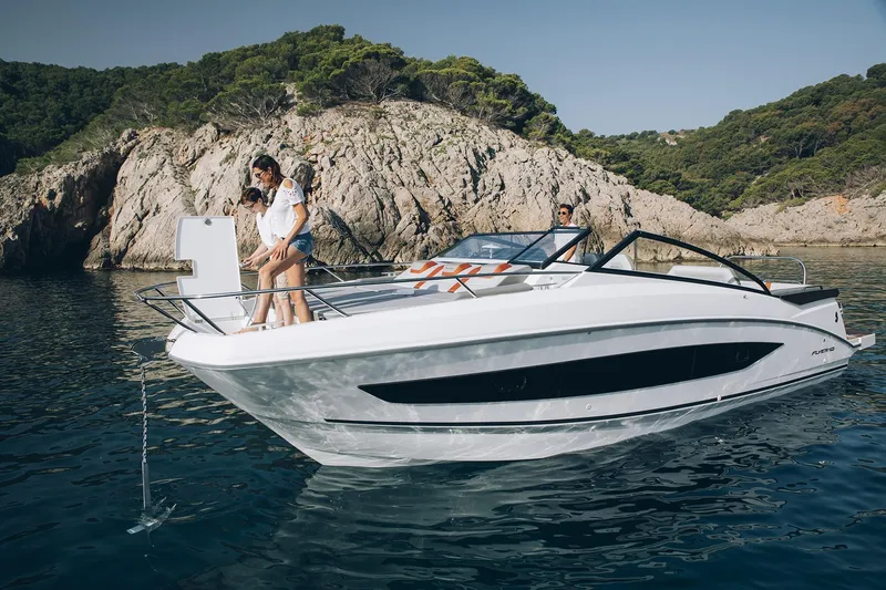 The Image of 2026 Beneteau Flyer 10 near rocky coast with people onboard. - 0