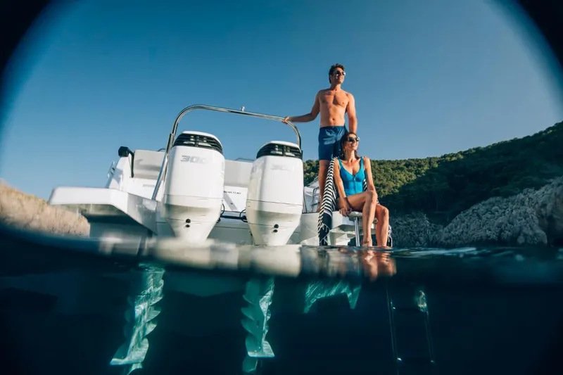 Slide: The Image of 2024 Beneteau Flyer 10 with two people enjoying the water. - 11