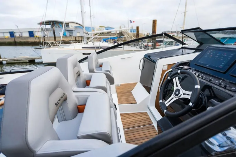 Slide: The Image of 2024 Beneteau Flyer 10 cockpit with modern steering wheel and comfortable seating. - 24