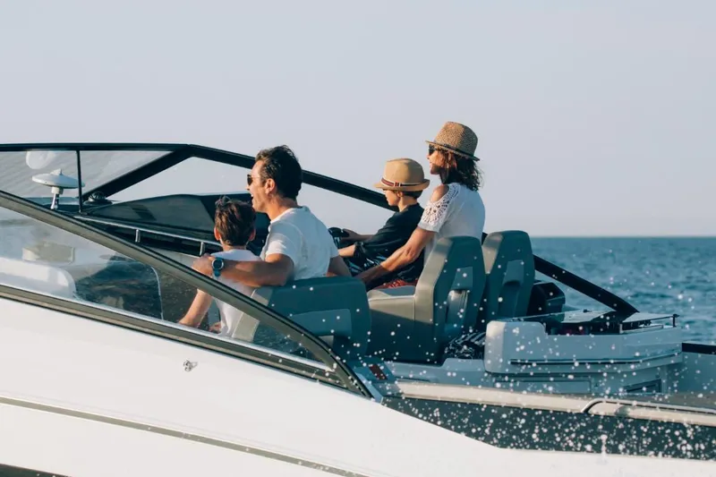 Slide: The Image of 2024 Beneteau Flyer 10 boat with passengers enjoying a sunny day on the water. - 32