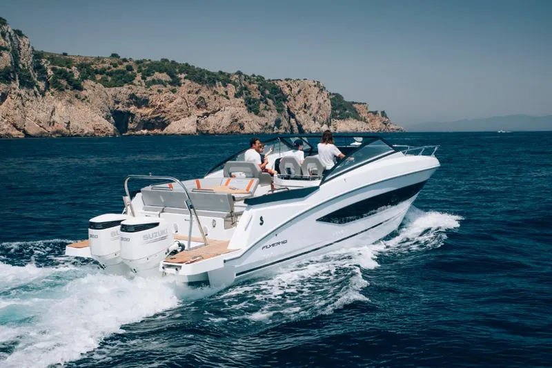 Slide: The Image of 2024 Beneteau Flyer 10 cruising on the ocean near rocky cliffs. - 4