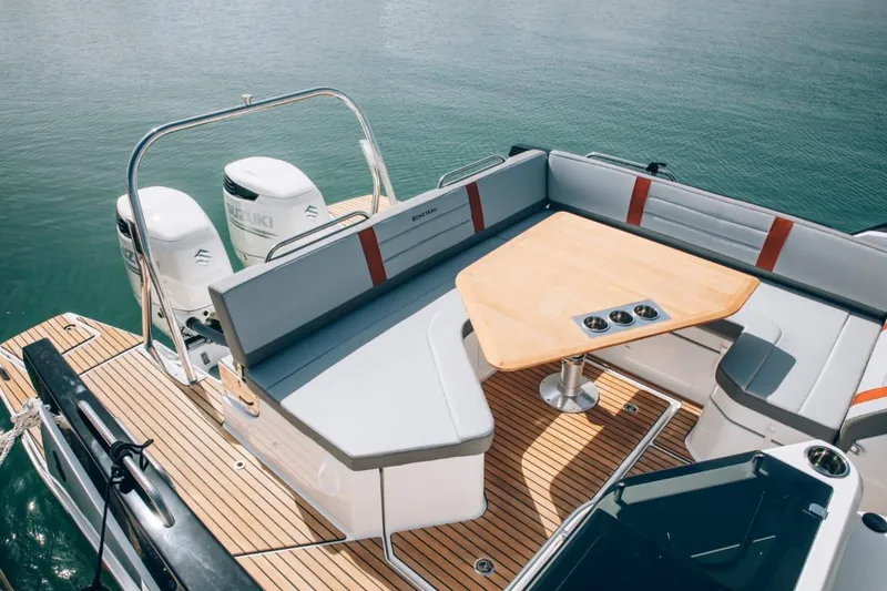 Slide: The Image of 2024 Beneteau Flyer 10 boat with spacious seating and wooden table on deck. - 41
