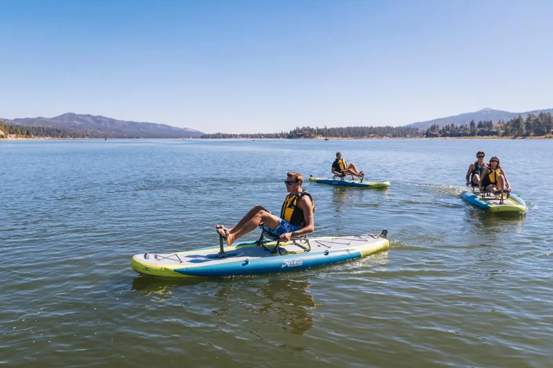 Slide: The Image of People enjoying a lake on 2023 Hobie ITREK 11 pedalboards. - 9