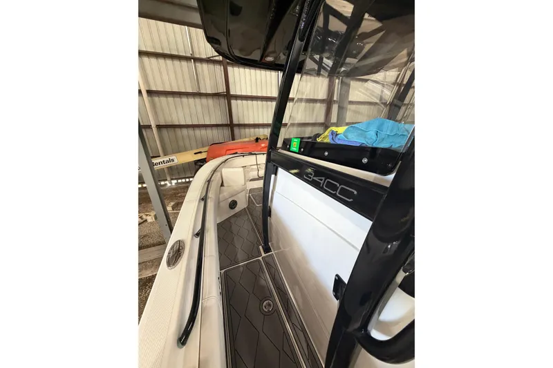 Slide: The Image of 2022 Fountain 34 Center Console boat interior with sleek design in storage facility. - 11
