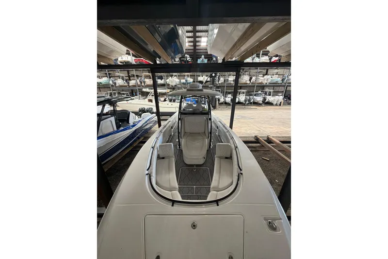 Slide: The Image of 2022 Fountain 34 Center Console boat in storage, showcasing sleek design and spacious seating. - 15