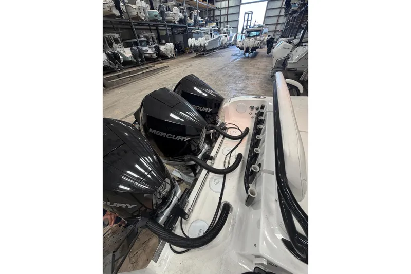Slide: The Image of 2022 Fountain 34 Center Console with triple Mercury engines in a storage facility. - 19