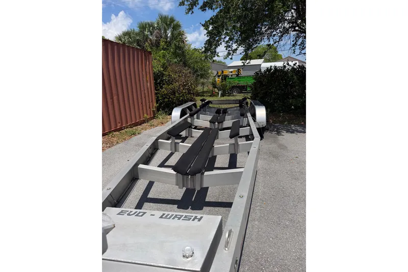 Slide: The Image of Boat trailer for 2022 Fountain 34 Center Console, parked outdoors near shipping container. - 25