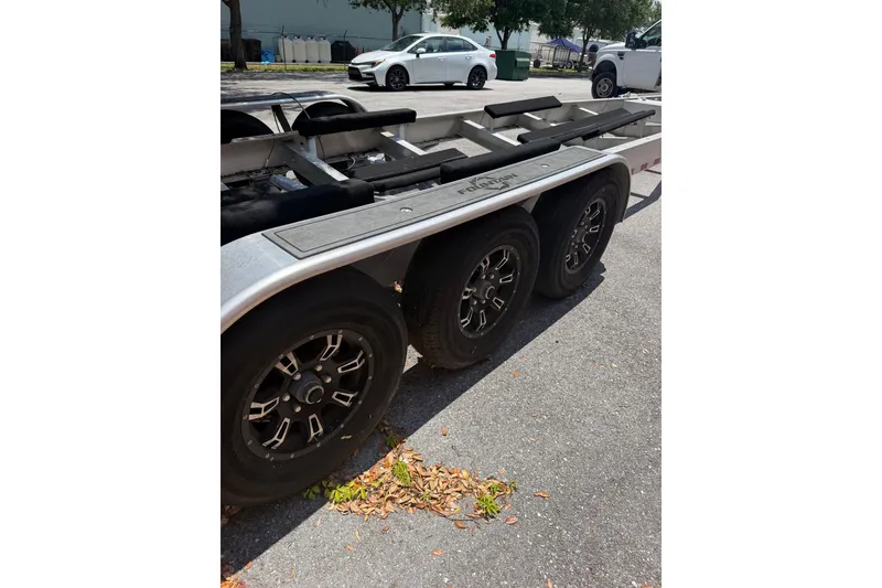 Slide: The Image of Triple-axle trailer for 2022 Fountain 34 Center Console boat on pavement. - 26