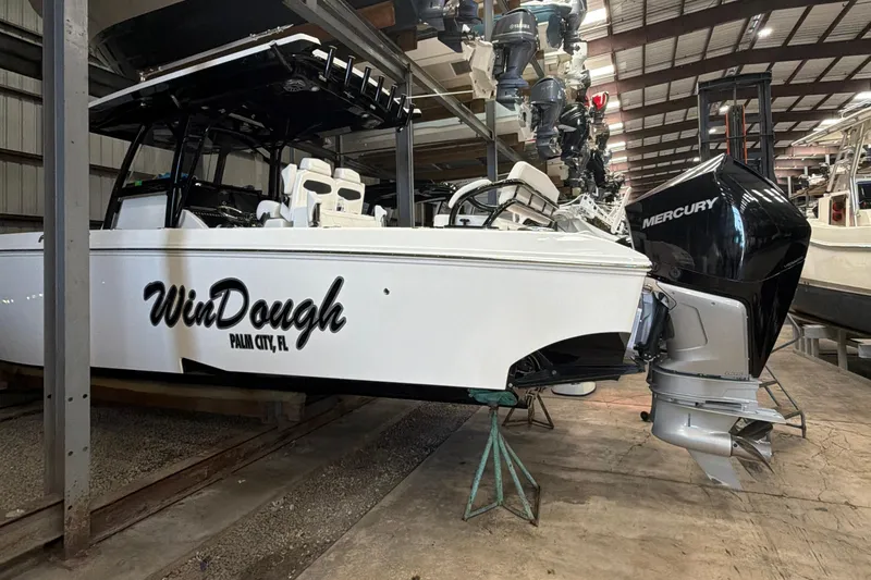 Slide: The Image of 2022 Fountain 34 Center Console boat in storage, featuring Mercury outboard engine. - 3