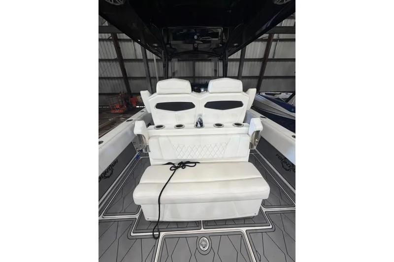 Slide: The Image of 2022 Fountain 34 Center Console boat interior with white seating and cup holders. - 5