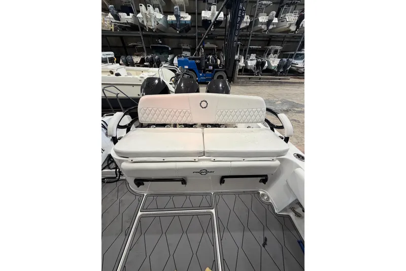 Slide: The Image of 2022 Fountain 34 Center Console boat interior with cushioned seating and dual engines. - 6