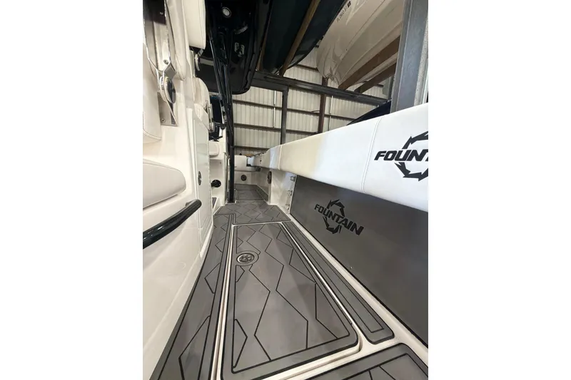 Slide: The Image of 2022 Fountain 34 Center Console boat interior with sleek flooring and branded seating. - 7