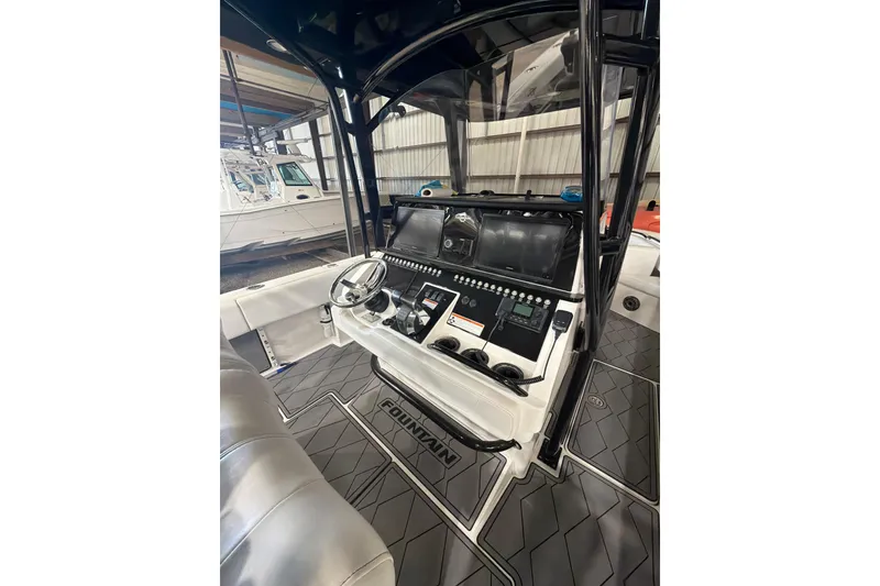 Slide: The Image of 2022 Fountain 34 Center Console boat interior with modern dashboard and steering wheel. - 8