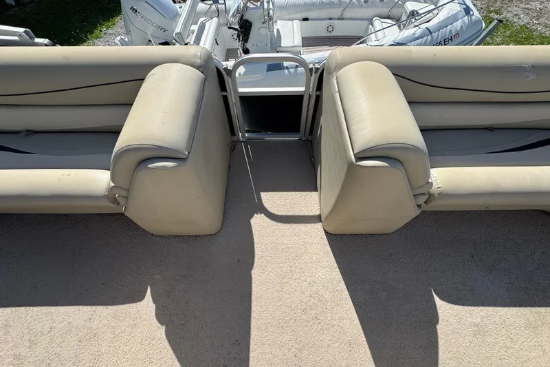 Slide: The Image of 2011 Bennington 2274GLi boat interior with beige seating and Mercury engine. - 3