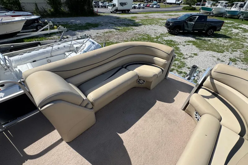 Slide: The Image of 2011 Bennington 2274GLi boat interior with beige seating and open deck view. - 4
