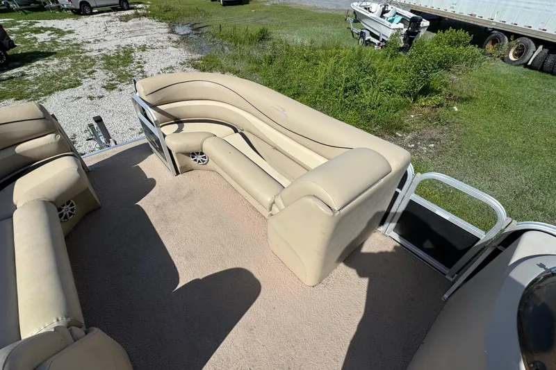 Slide: The Image of 2011 Bennington 2274GLi pontoon boat interior with beige seating and carpet. - 5