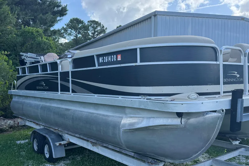 Slide: The Image of 2011 Bennington 2274GLi pontoon boat on trailer, parked outdoors. - 8