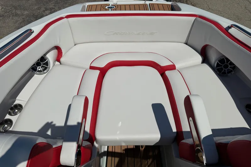 Slide: The Image of 2025 Crownline Eclipse E235 boat interior with white and red seating, featuring cup holders and speakers. - 12