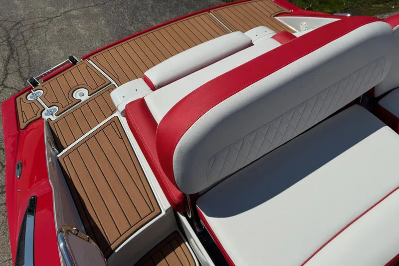 Slide: The Image of 2025 Crownline Eclipse E235 boat interior with red and white seating, teak-style flooring. - 4