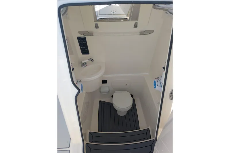 Slide: The Image of 2020 Cobia 262 Center Console boat interior with toilet and sink. - 10