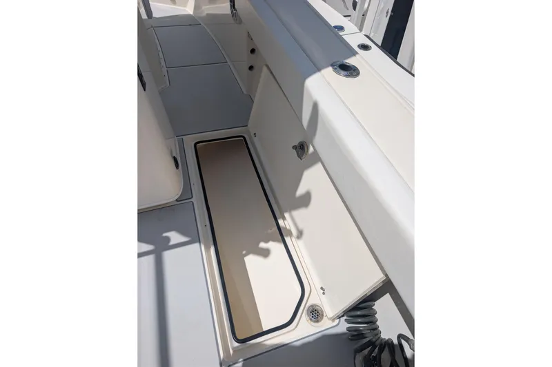 Slide: The Image of 2020 Cobia 262 Center Console boat interior with open storage compartment. - 14