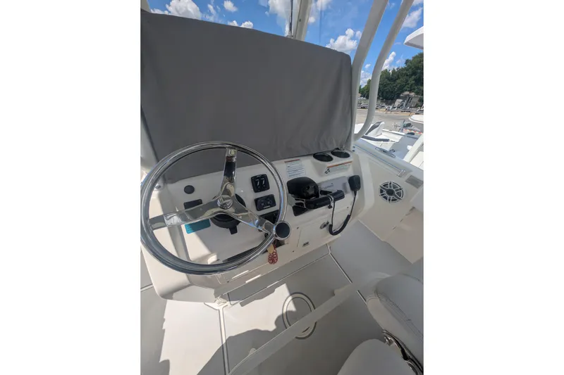 Slide: The Image of 2020 Cobia 262 Center Console boat helm with steering wheel and controls. - 17