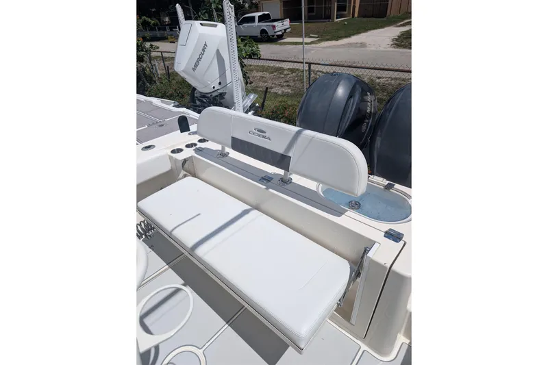 Slide: The Image of 2020 Cobia 262 Center Console boat interior with seating and Mercury outboard motor. - 4