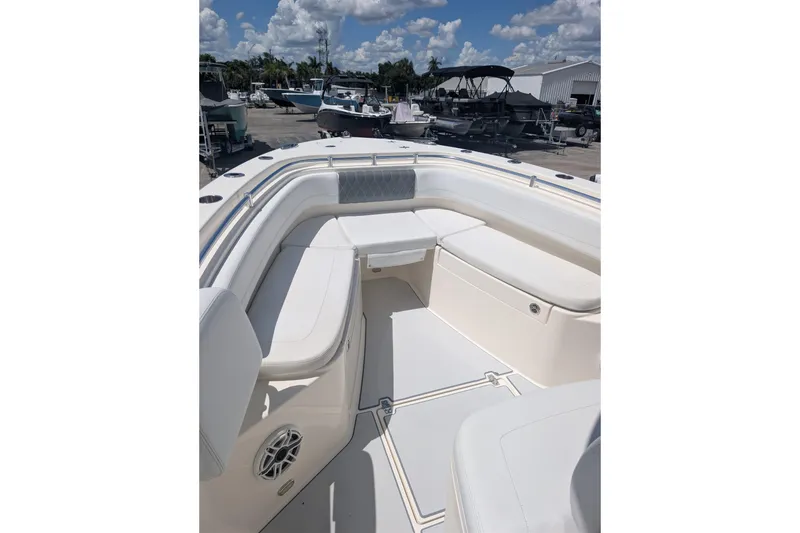 Slide: The Image of 2020 Cobia 262 Center Console boat interior with white seating and clear sky background. - 7