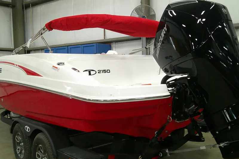The Image of 2026 Tahoe 2150 boat with red and white design, featuring a Mercury outboard motor. - 0