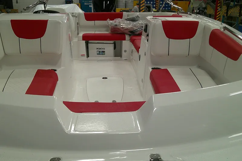 Slide: The Image of Interior of a 2026 Tahoe 2150 boat with red and white seating. - 2