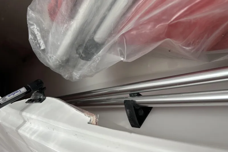 Slide: The Image of Close-up of Tahoe 2150 boat components, featuring metal rods and plastic coverings, 2026 model. - 3