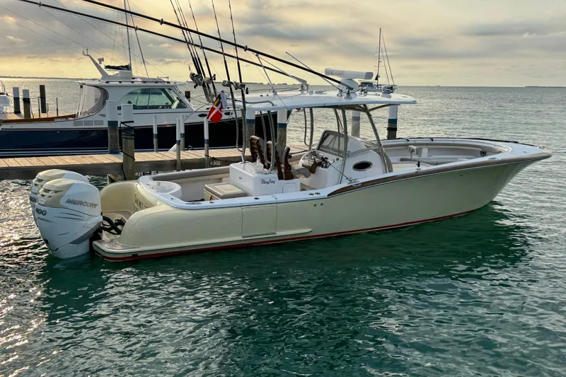 Slide: The Image of 2020 Mag Bay 33 CC boat docked, featuring sleek design and powerful Mercury outboard engine. - 10
