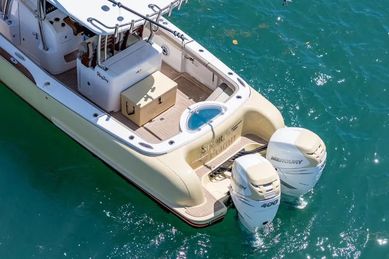 Slide: The Image of 2020 Mag Bay 33 CC boat with twin Mercury 400 engines on clear water. - 14
