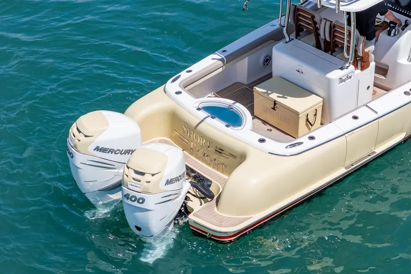 Slide: The Image of 2020 Mag Bay 33 CC boat with twin Mercury 400 engines on blue water. - 15