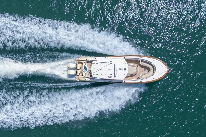 Slide: The Image of Aerial view of 2020 Mag Bay 33 CC boat cruising on open water. - 16