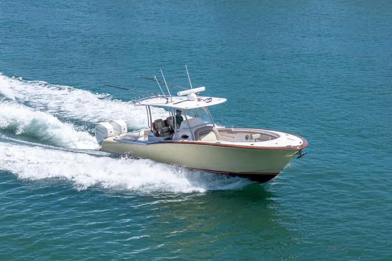 Slide: The Image of 2020 Mag Bay 33 CC boat cruising on clear blue water. - 17
