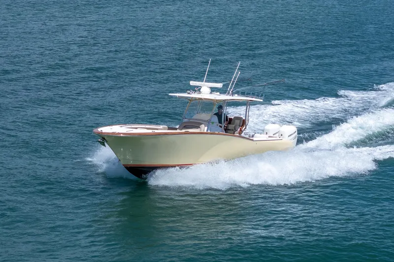 Slide: The Image of 2020 Mag Bay 33 CC boat cruising on open water. - 18