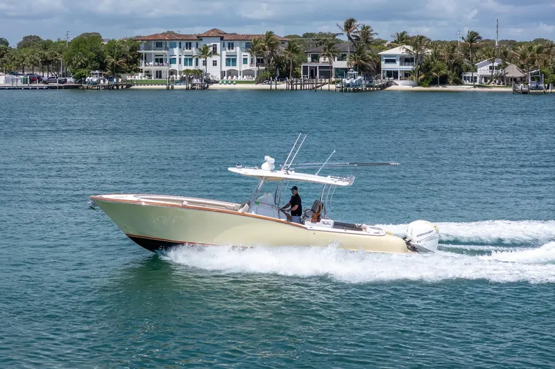 Slide: The Image of 2020 Mag Bay 33 CC cruising on water near coastal homes. - 19