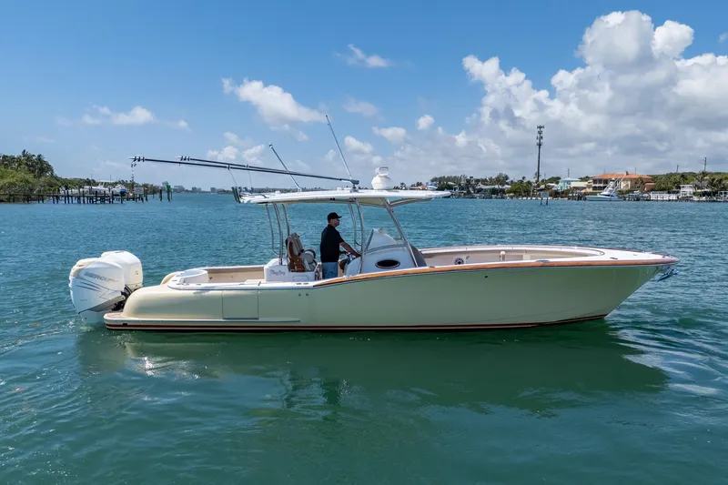 Slide: The Image of 2020 Mag Bay 33 CC boat cruising on a sunny day with clear skies. - 2