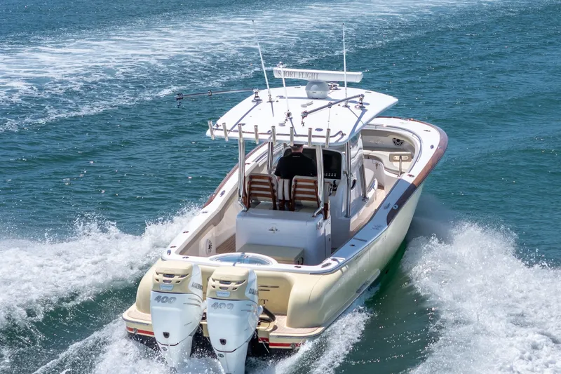 Slide: The Image of 2020 Mag Bay 33 CC boat cruising on open water, rear view. - 21